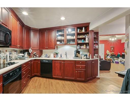 216 Haverhill Road Topsfield, MA 01983 - Photo 20 of 28 a kitchen with stainless steel appliances granite countertop a sink dishwasher stove and cabinets with wooden floor