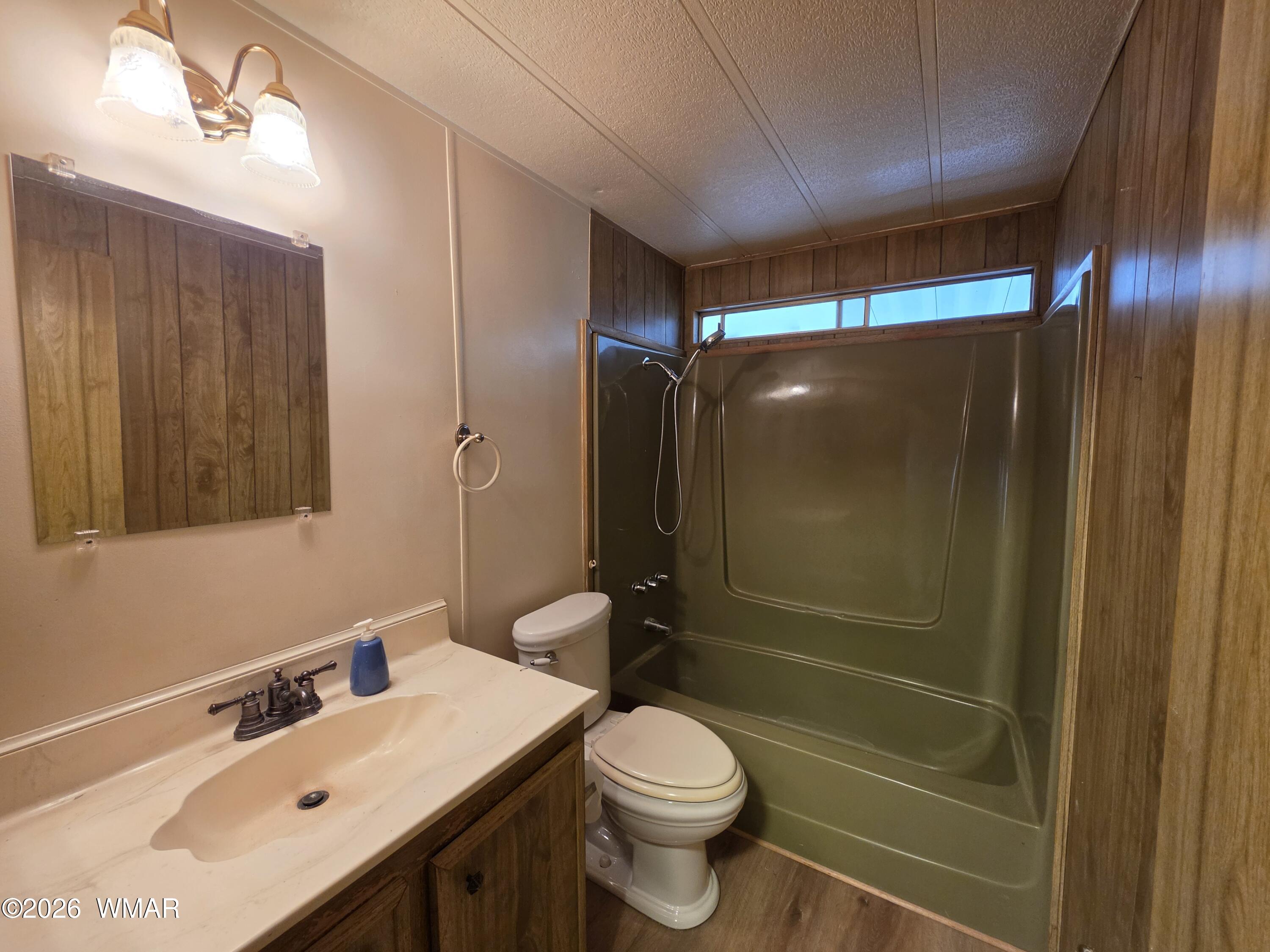 2800 South White Mountain Road, Unit 84 Show Low, AZ 85901 - Photo 11 of 13 a bathroom with a sink mirror vanity and toilet