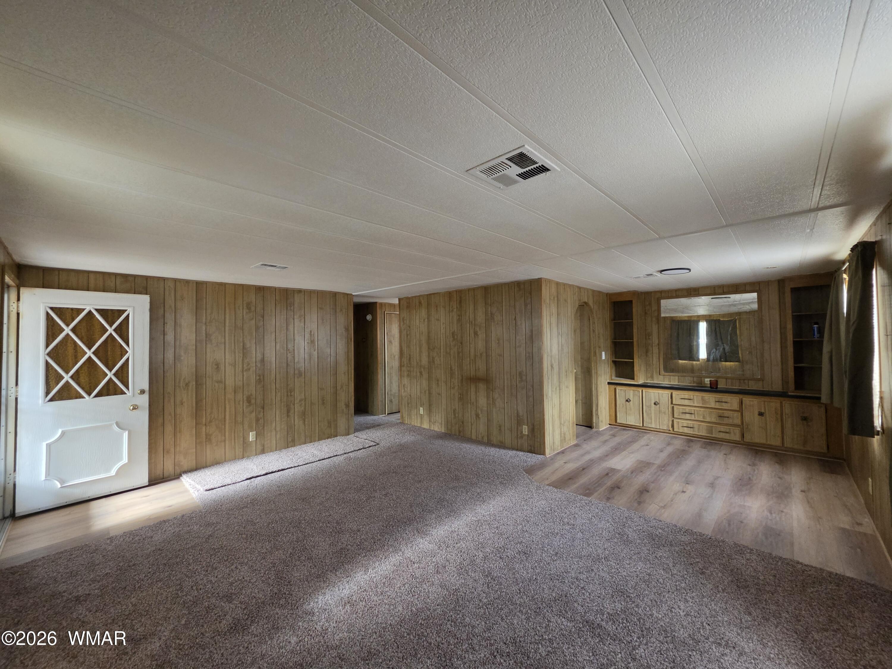 2800 South White Mountain Road, Unit 84 Show Low, AZ 85901 - Photo 5 of 13 an empty room with entrance and windows
