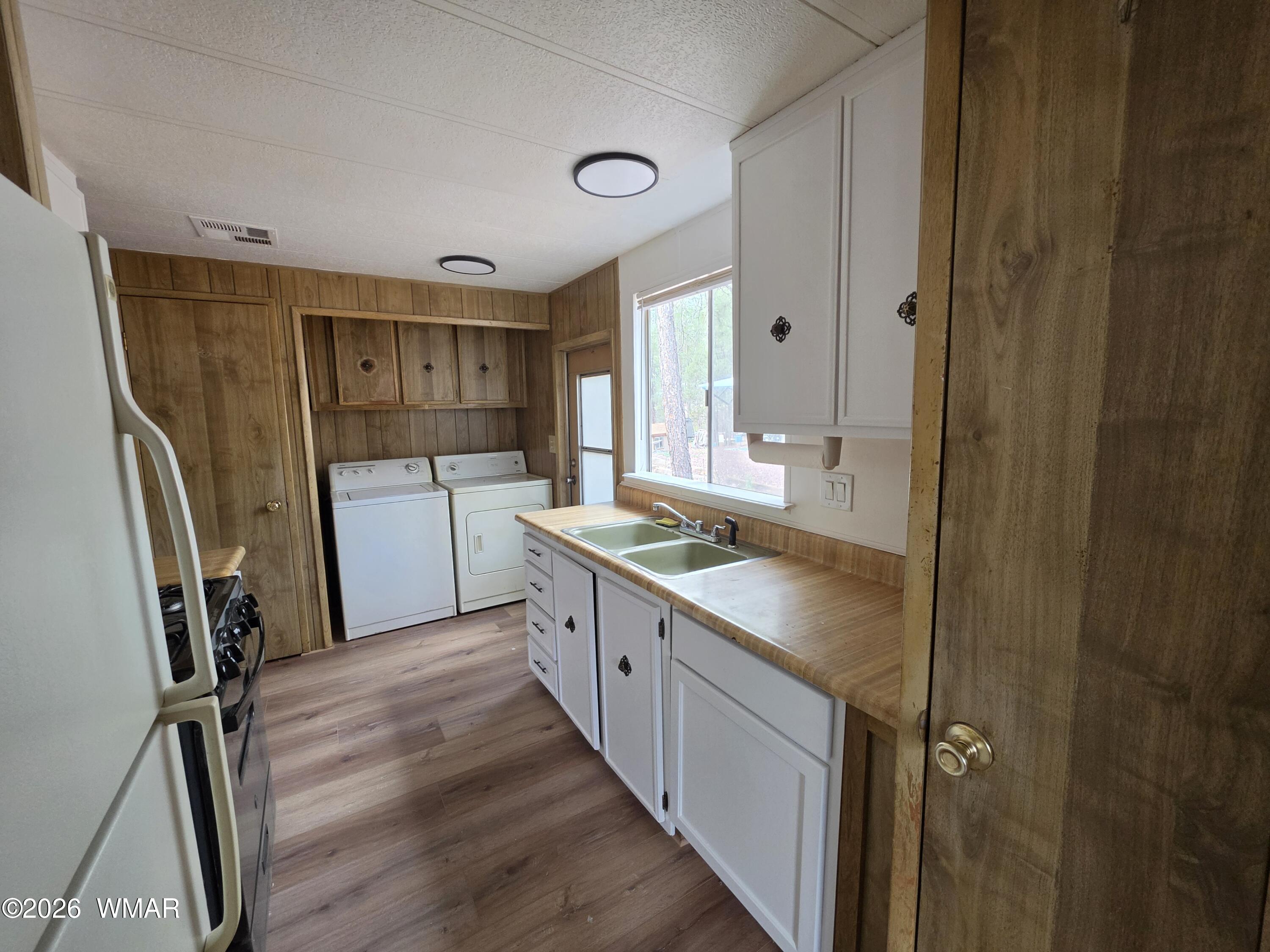 2800 South White Mountain Road, Unit 84 Show Low, AZ 85901 - Photo 6 of 13 a kitchen with a sink stove and refrigerator
