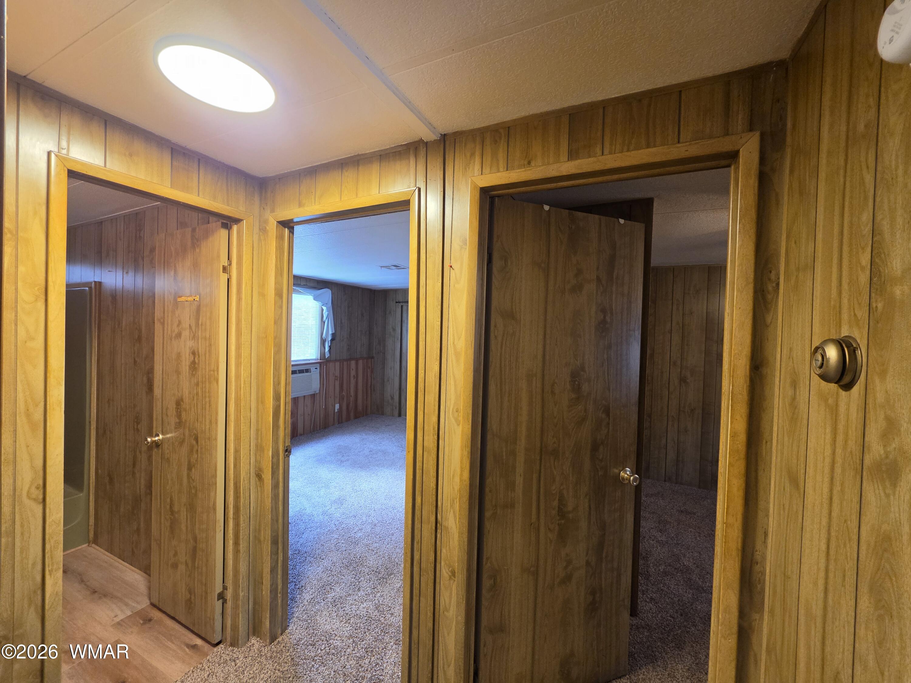 2800 South White Mountain Road, Unit 84 Show Low, AZ 85901 - Photo 8 of 13 a view of a hallway with wooden floor