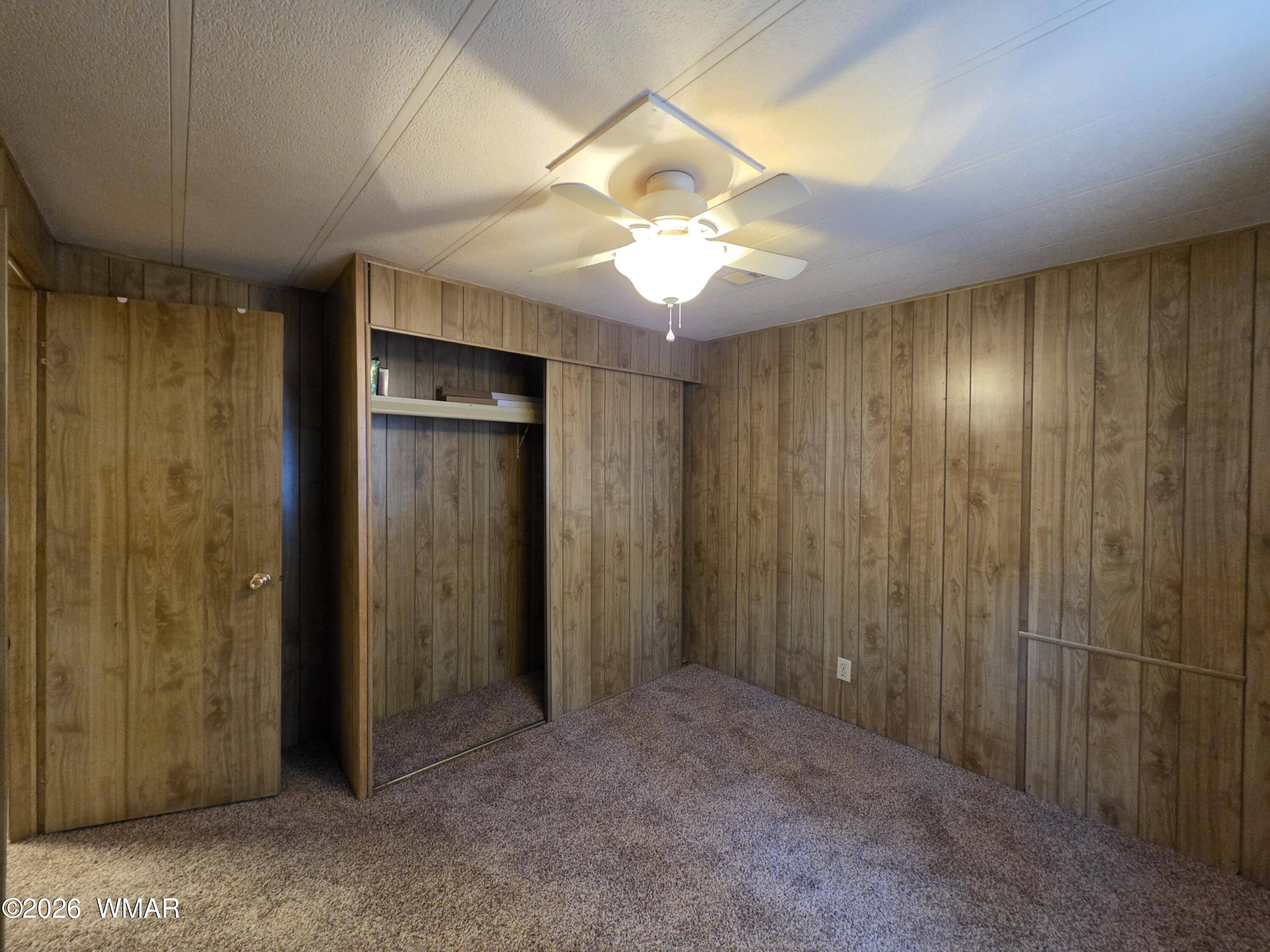 2800 South White Mountain Road, Unit 84 Show Low, AZ 85901 - Photo 10 of 13 a view of a hallway with a chandelier fan