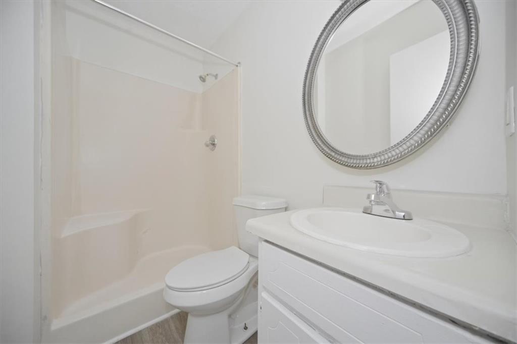 1496 Cherry Hill Road Southwest Conyers, GA 30094 - Photo 18 of 32 a bathroom with a sink a toilet and a mirror