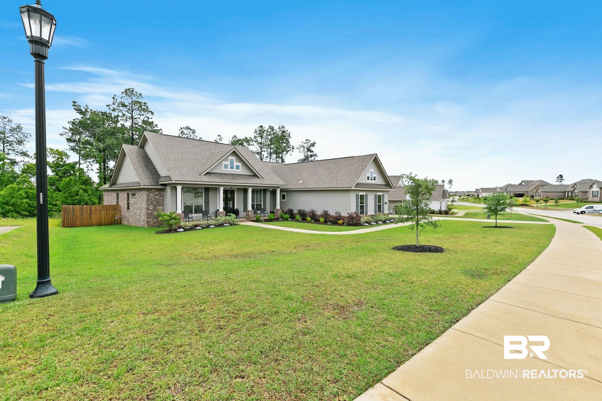 13233 Ibis Boulevard Daphne, AL 36527 - Photo 65 of 100 Contemporary ranch-style residence featuring a brick and siding exterior, a covered front porch with white columns, and a gabled roofline