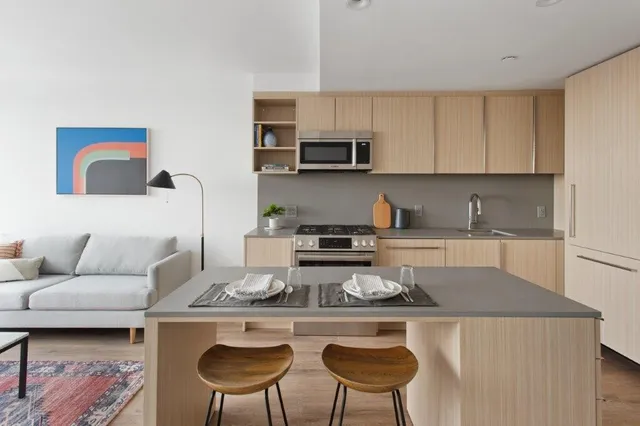 a kitchen with a stove a sink and a refrigerator