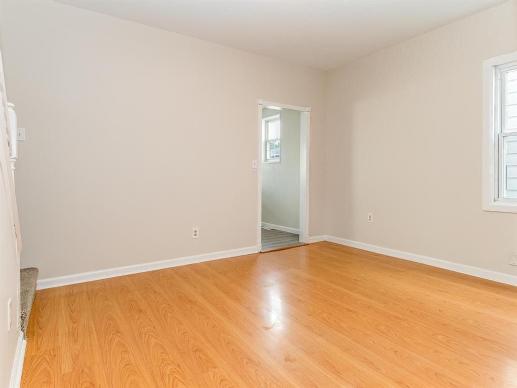 448 Park Street Rochester, PA 15074 - Photo 9 of 29 a view of an empty room with wooden floor and a window