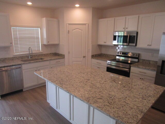 4165 Deer Trce Lane Jacksonville, FL 32257 - Photo 3 of 13 a kitchen with stainless steel appliances granite countertop a sink stove and microwave