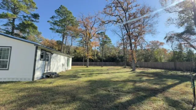 a view of a backyard with large tree