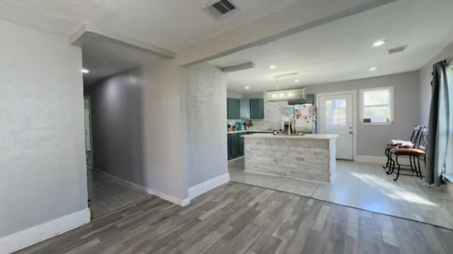 a view of kitchen with furniture and wooden floor