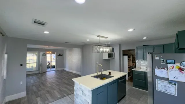 a kitchen with stainless steel appliances granite countertop a sink stove and refrigerator