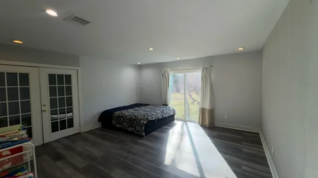 a spacious bedroom with a bed and a window