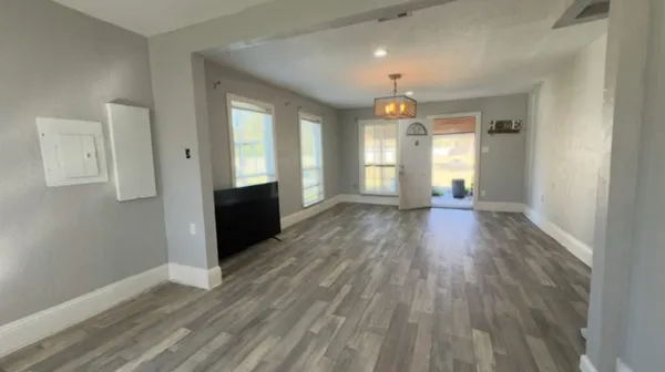 wooden floor in an empty room with a window