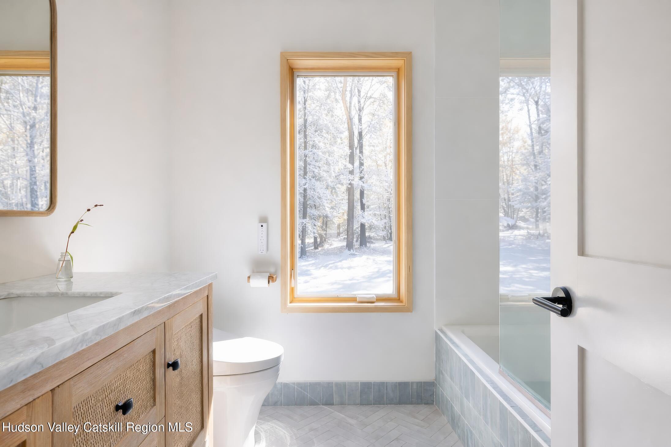 130 Abromowitz Road Wawarsing, NY 12428 - Photo 18 of 27 a bathroom with a granite countertop toilet a sink and a bathtub