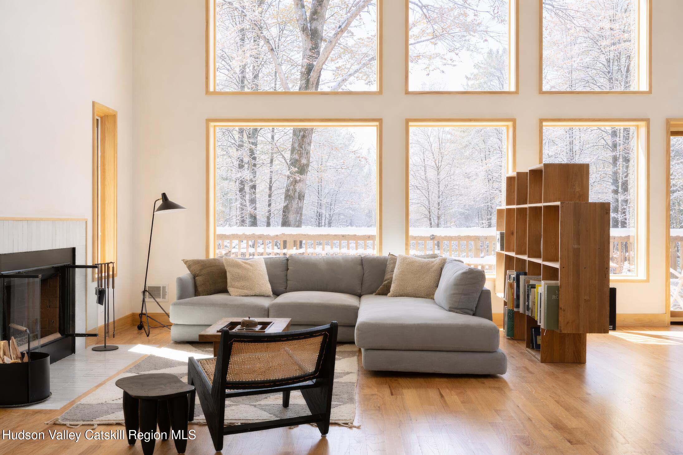130 Abromowitz Road Wawarsing, NY 12428 - Photo 5 of 27 a living room with furniture a fireplace and a flat screen tv