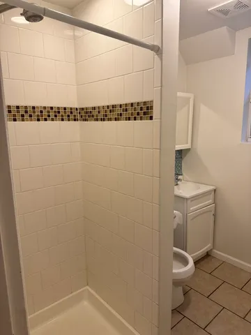 a bathroom with a shower and a toilet