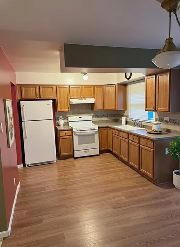 a kitchen with stainless steel appliances granite countertop a sink and cabinets