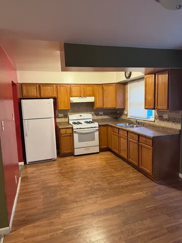 a kitchen with stainless steel appliances granite countertop a stove and a sink