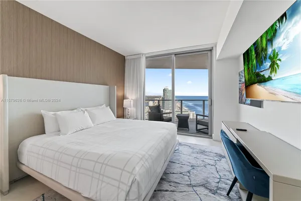 a large bedroom with a large bed and a large window