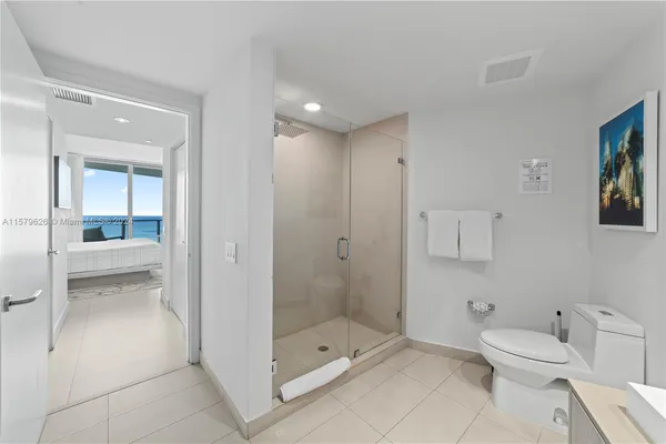 a bathroom with a toilet a sink and shower