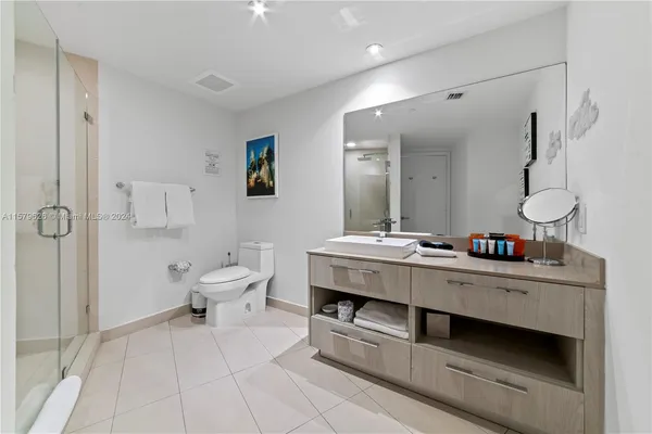 a bathroom with a double vanity sink mirror and toilet