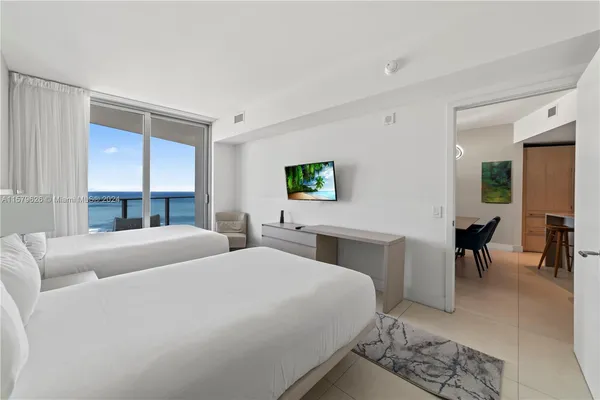 a bed room with two bed and a couch