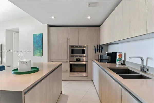 a kitchen with a sink and white cabinets