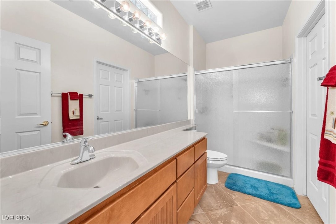 3056 Monroe Park Road Henderson, NV 89052 - Photo 14 of 28 Full bathroom featuring vanity, tile patterned flooring, and a shower stall