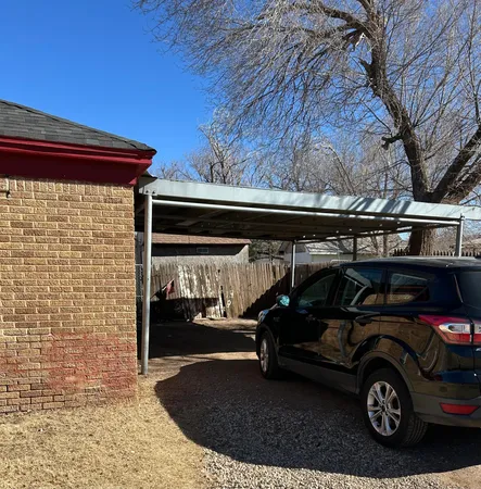 a view of a car parked front of a house