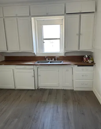 a view of a kitchen with sink and cabinets