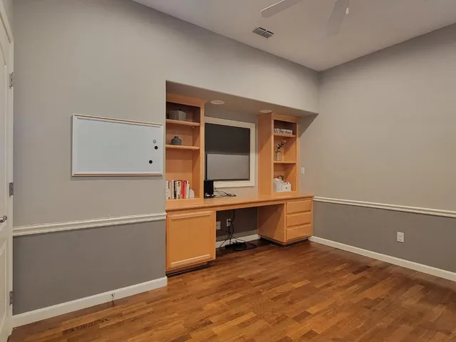 a living room with furniture a dining table and a chandelier