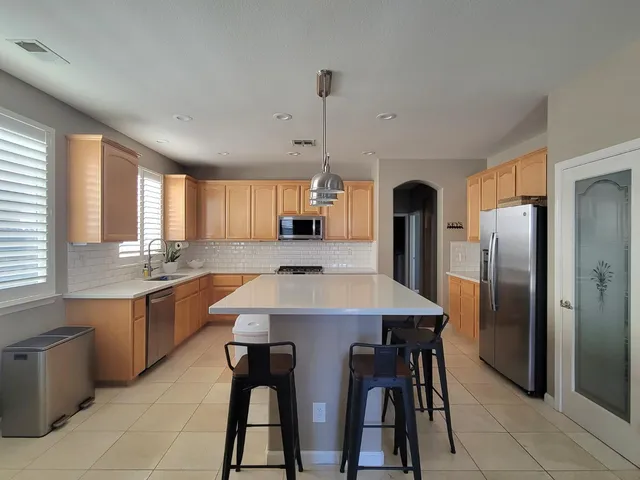 a kitchen with a sink a counter space and appliances