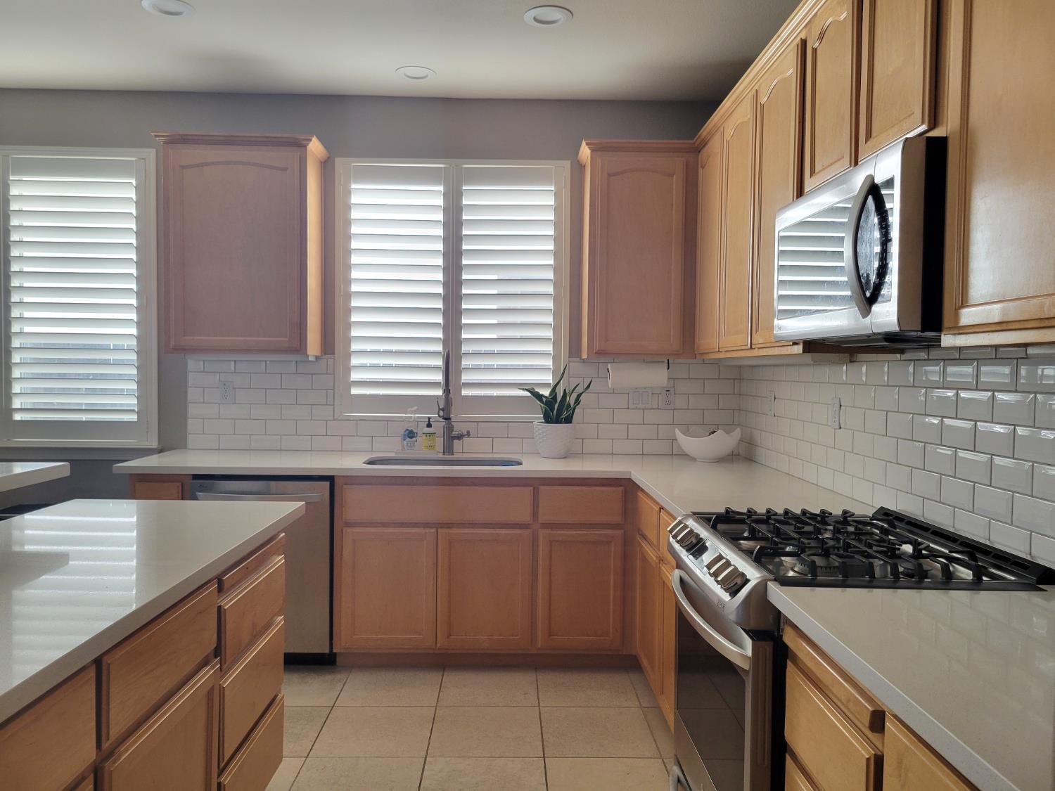 1607 Three Rivers Drive Marysville, CA 95901 - Photo 21 of 47 a kitchen with a sink a stove cabinets and a window