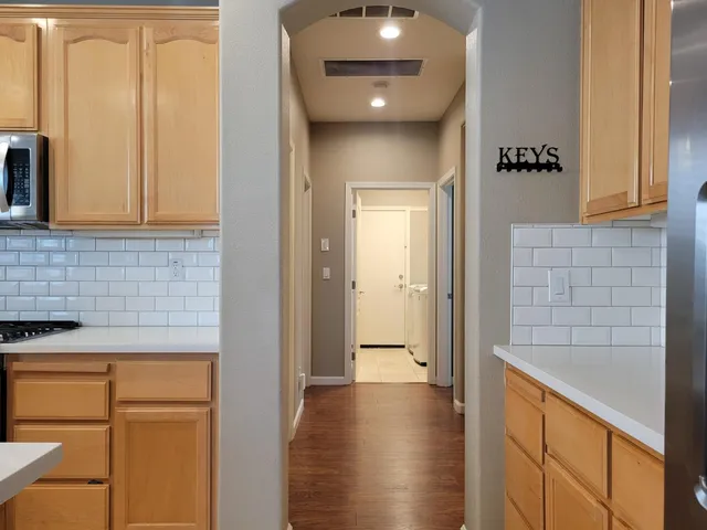 a view of room with mirror and dual sinks