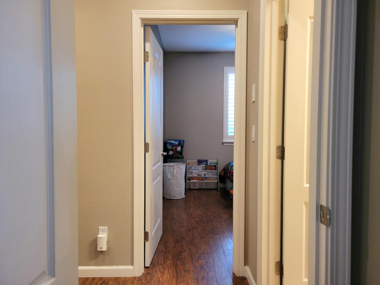 1607 Three Rivers Drive Marysville, CA 95901 - Photo 29 of 47 a view of a hallway with couch and wooden floor