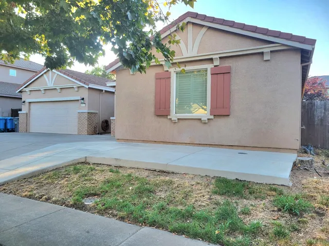 a view of a hallway with wooden walls and door