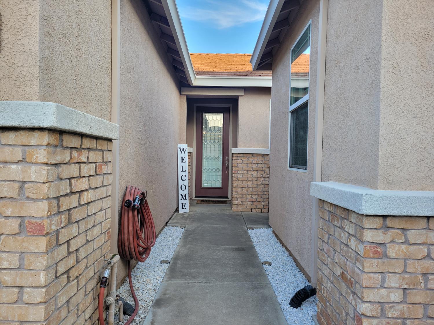 1607 Three Rivers Drive Marysville, CA 95901 - Photo 4 of 47 a view of a hallway with wooden walls and door