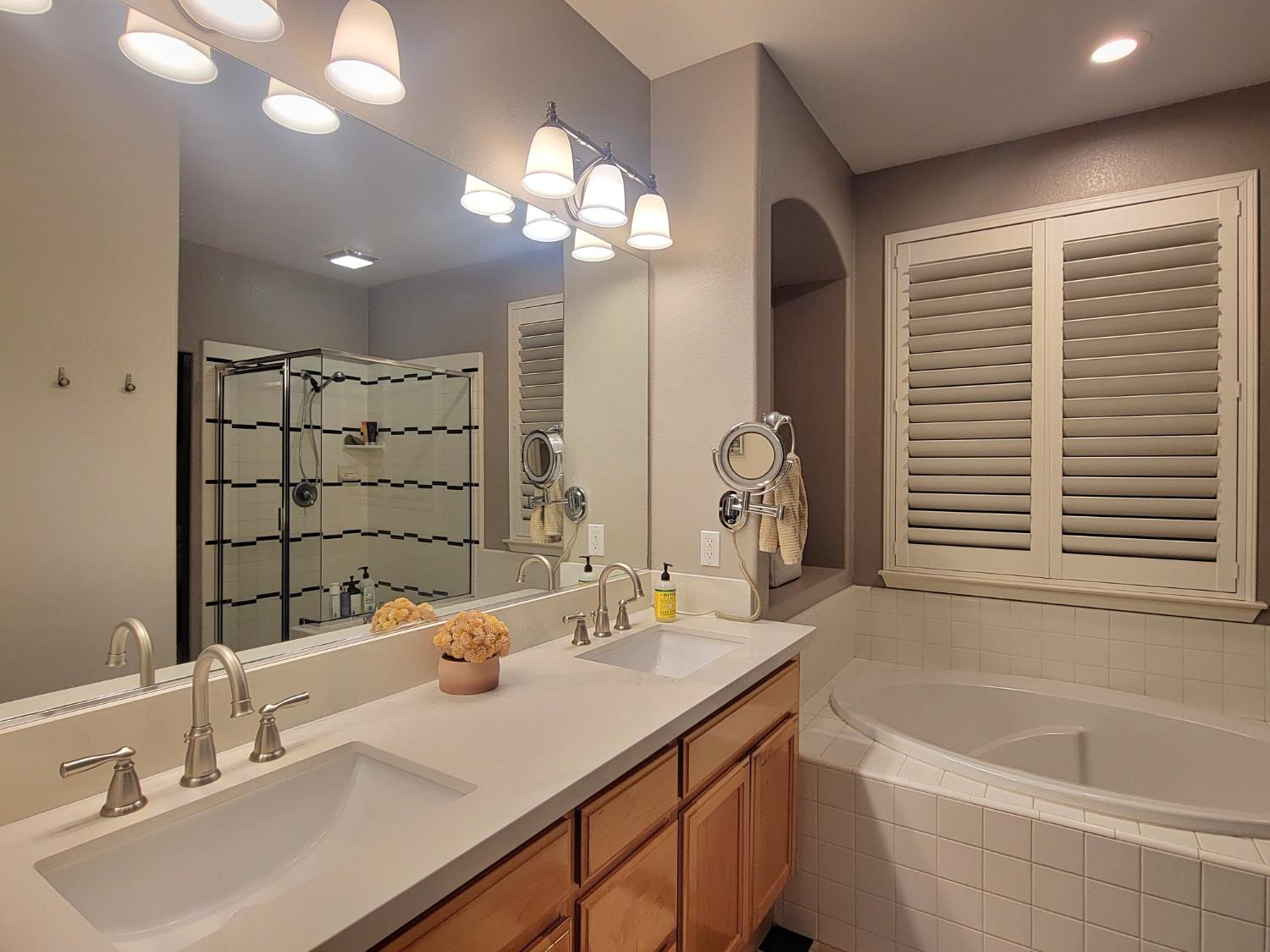 1607 Three Rivers Drive Marysville, CA 95901 - Photo 45 of 47 a bathroom with a bathtub a sink and a large mirror