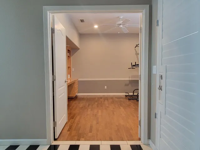 a room with wooden floor and white walls