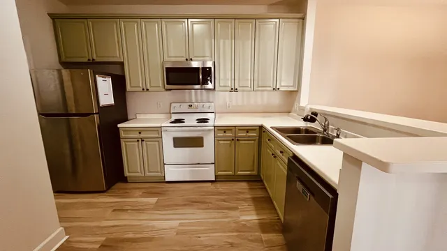 a kitchen with a sink stove and refrigerator