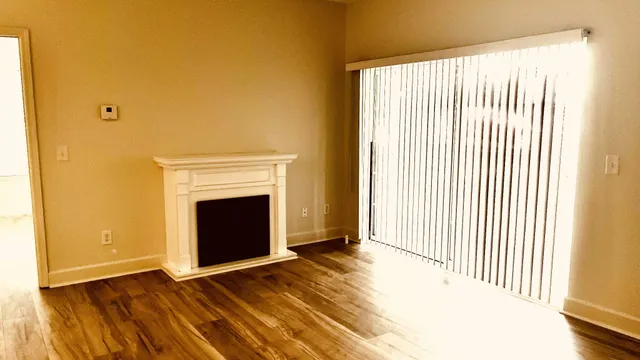 a view of a livingroom with a fireplace and window