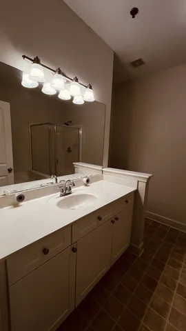 a bathroom with a double vanity sink and a mirror