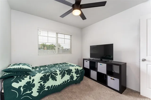 a bedroom with bed and tv