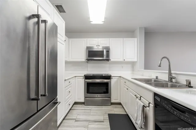 a kitchen with stainless steel appliances a stove sink and refrigerator