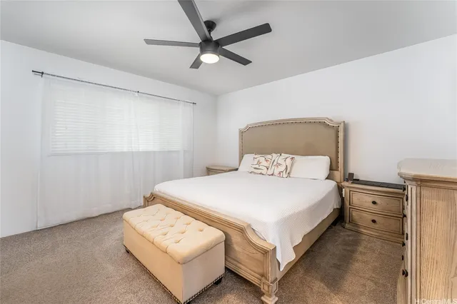 a bedroom with a bed and a ceiling fan