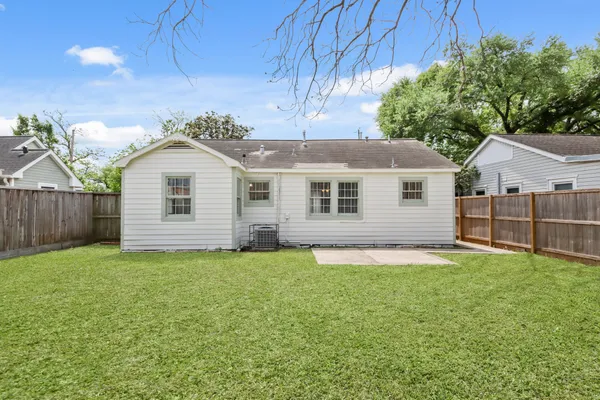 a view of a house with a yard and deck