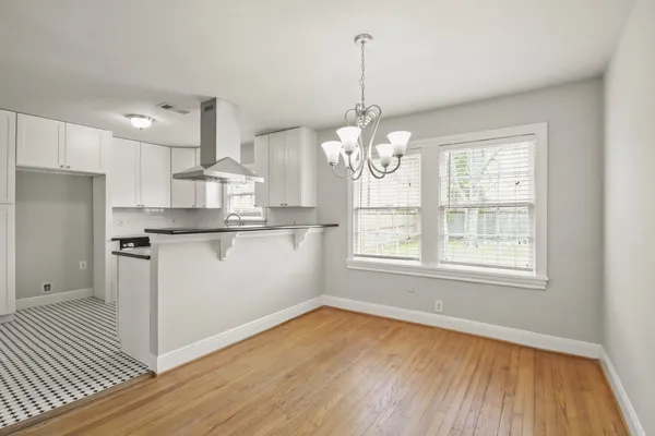 a view of a kitchen with marble countertop stainless steel appliances and wooden floor