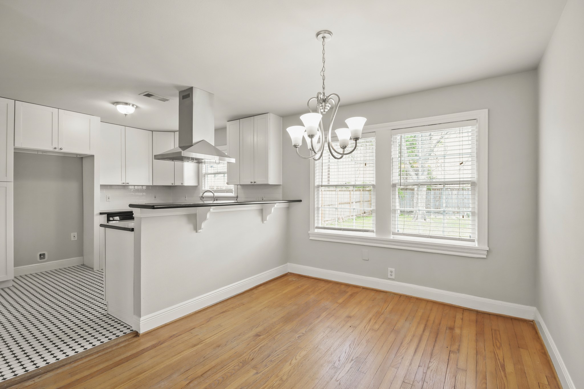 927 Walling Street Houston, TX 77009 - Photo 3 of 13 a view of a kitchen with marble countertop stainless steel appliances and wooden floor