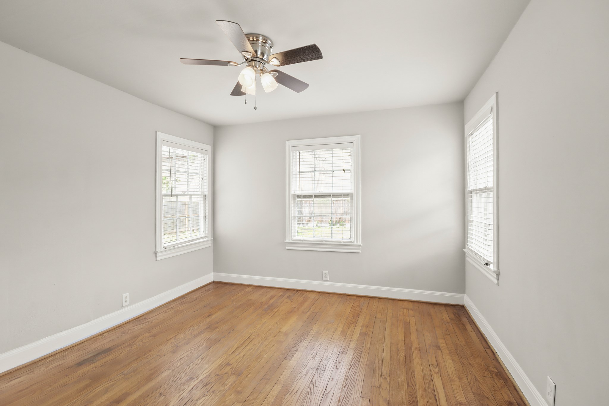 927 Walling Street Houston, TX 77009 - Photo 7 of 13 wooden floor in an empty room with a window