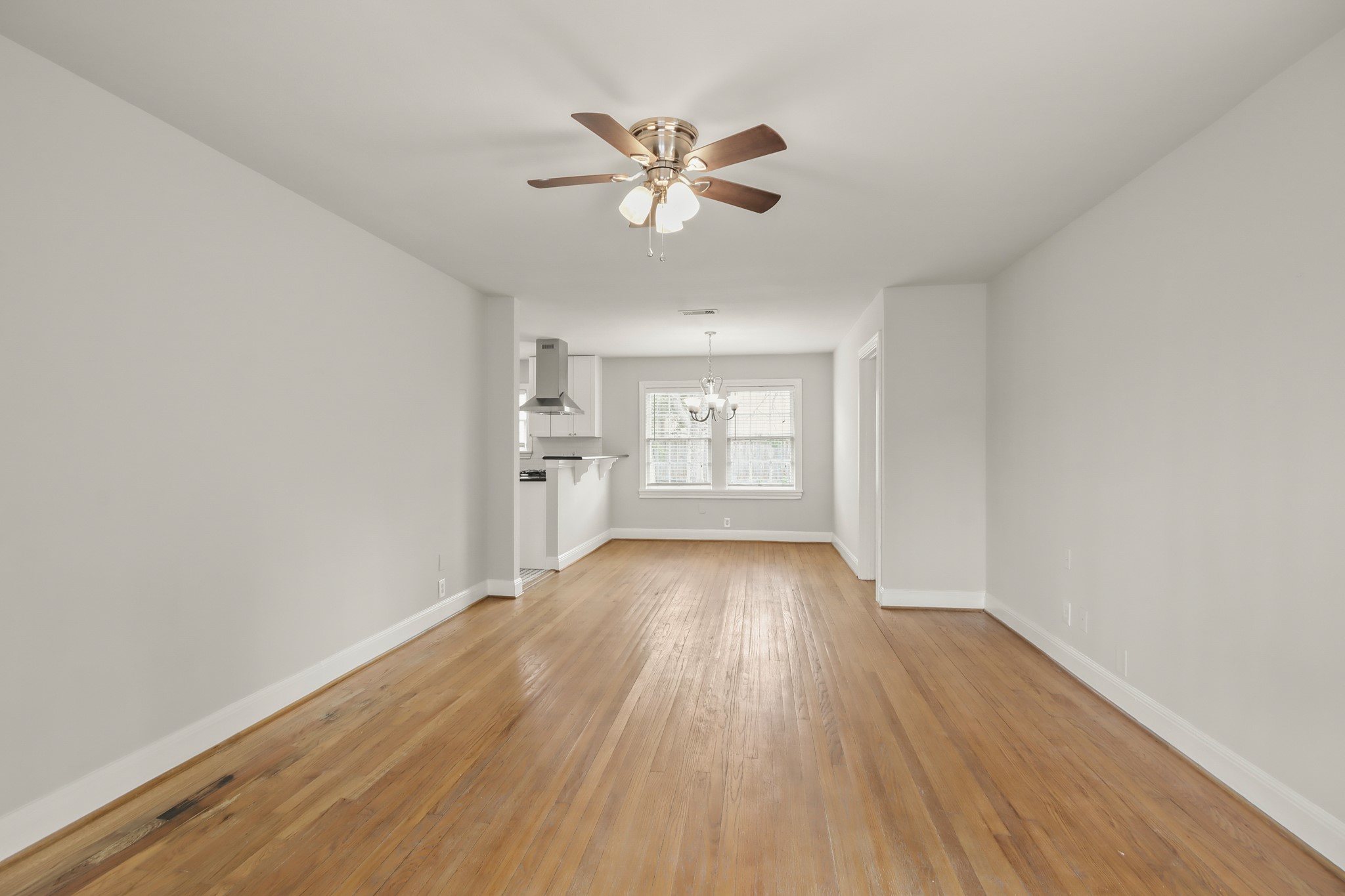 927 Walling Street Houston, TX 77009 - Photo 10 of 13 wooden floor in an empty room with a window