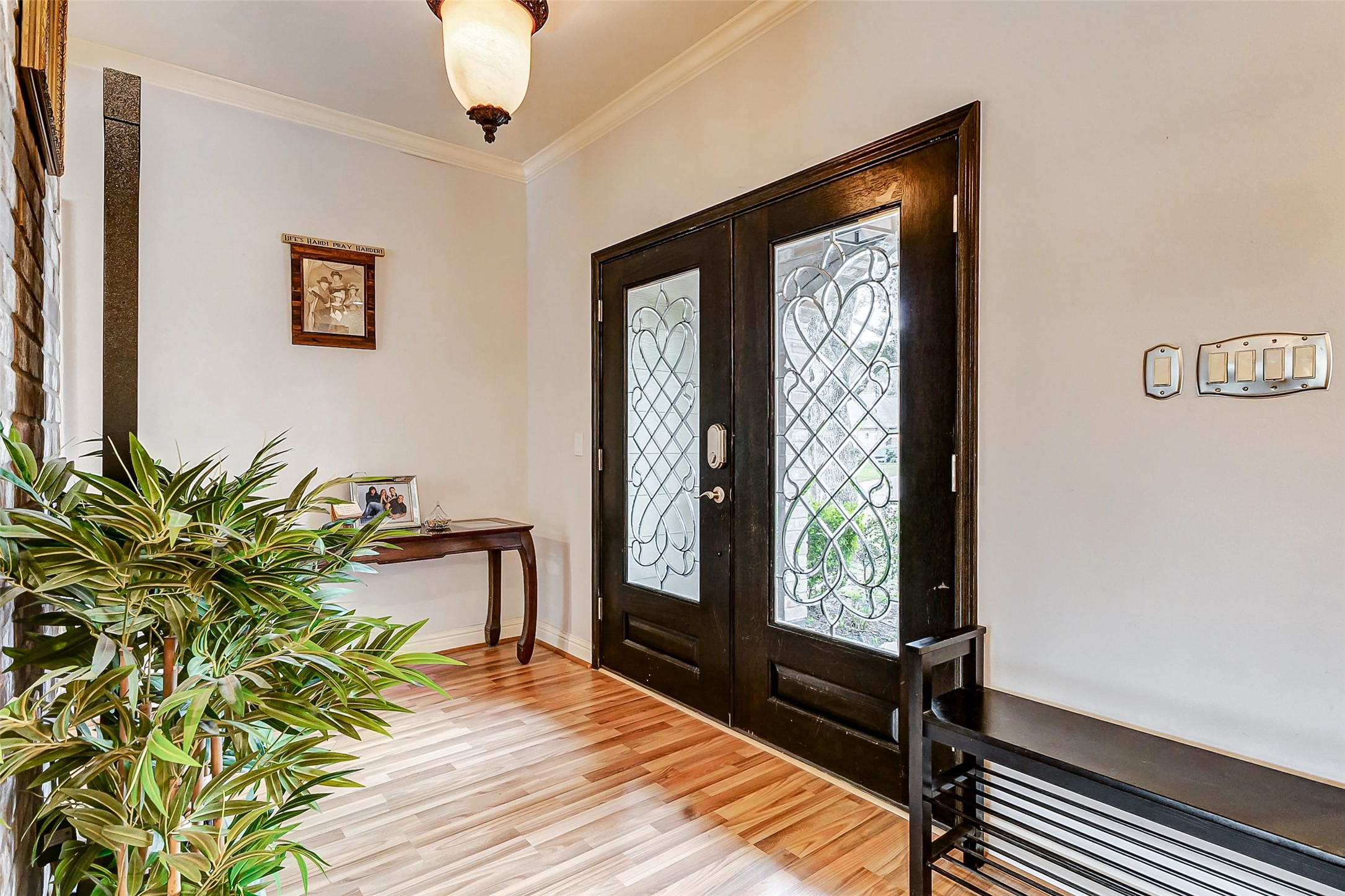 3022 Triway Lane Houston, TX 77043 - Photo 5 of 43 Bathed in natural light from the glass-paneled doors, this welcoming entryway sets the tone for the home’s refined aesthetic. Gleaming floors, soft neutral hues, and a flush-mount fixture add warmth and elegance to this first impression.